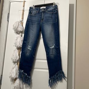 Skinny jeans with frayed edged bottoms